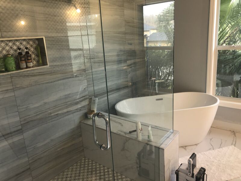 Master bathroom renovation with book-matched porcelain and a double vanity