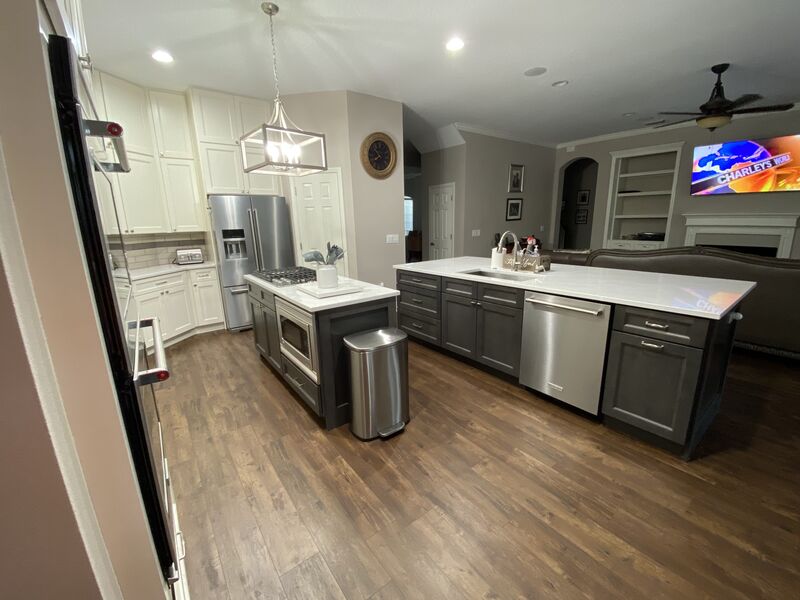 Gas cooktop island and full-height cabinetry in a completed kitchen remodel