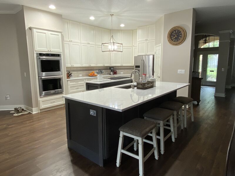 Remodeled Tampa kitchen with white cabinetry and a dark quartz-topped island